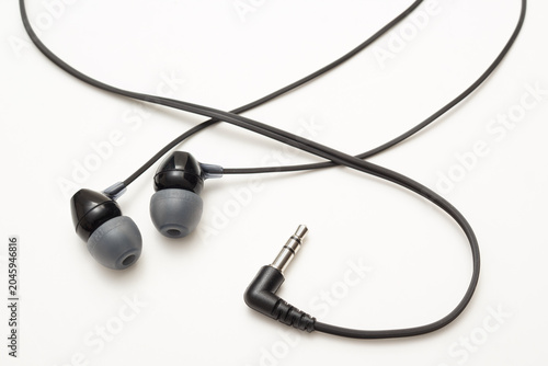 Wired earbuds isolated on a white background with a clean minimal design and detailed audio accessory appearance.