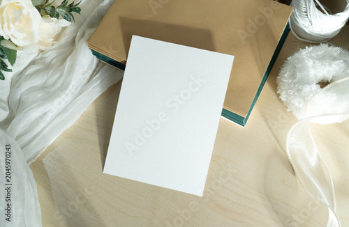 Mockup white blank space card, for greeting, table number, invitation template with soft blurred flowers, perfect for wedding or Valentine’s greeting design, with clipping path.