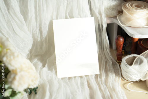 Mockup white blank space card, for greeting, table number, invitation template with soft blurred flowers, perfect for wedding or Valentine’s greeting design, with clipping path.