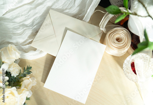Mockup white blank space card, for greeting, table number, invitation template with soft blurred flowers, perfect for wedding or Valentine’s greeting design, with clipping path.