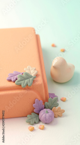 3D clay fall composition with orange book block, candy canes and miniature pumpkins on pastel mint background [text space]