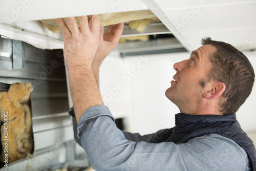 Quadro su tela cheerful plasterer worker at a indoors wall insulation works