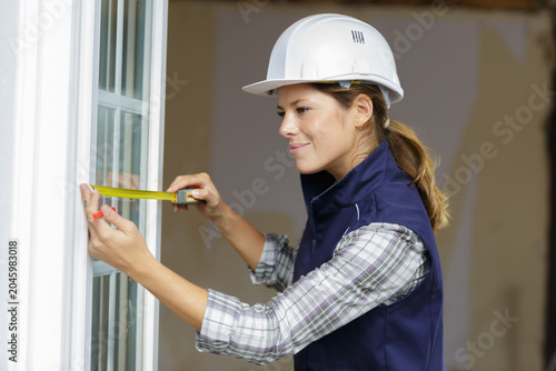 portrait of a woman measuring window