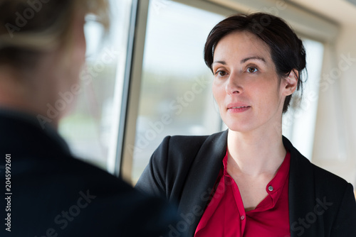 an aprehensive businesswoman in conversation