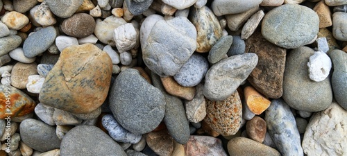 Photography A clean layout of polished river rocks showcasing versatile elements, excellent