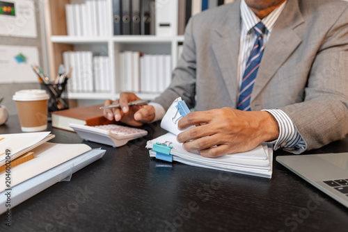 Quadro su tela Businessman organizing documents and financial paperwork at his office, focusing on accuracy, responsibility, and efficient management to support daily business operations