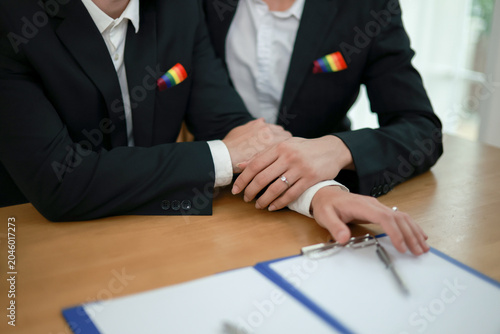 Gay couple from the LGBTQ community fulfilled their dream by legally and equally registering their marriage happily signing the marriage certificate in front of a witnessed registrar.