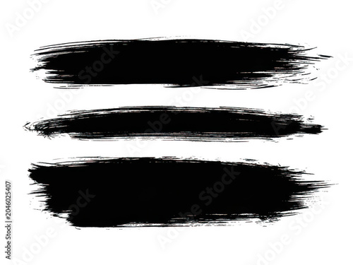Three black ink splashes on clean background
