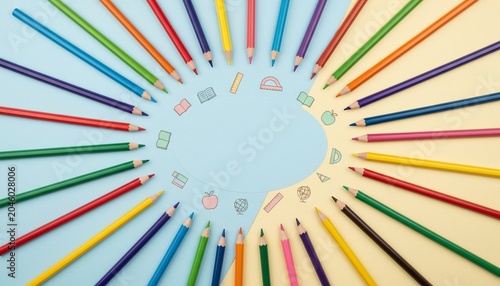 Circle of colored pencils with school doodles