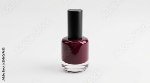 Deep burgundy nail polish in a clear bottle on white, clean beauty product still life for cosmetics, manicure and retail campaigns, glossy liquid detail, minimal styling, elegant color focus, balanced