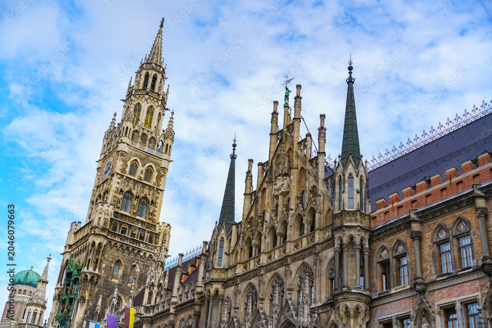 Obraz premium Detailed view of the New Town Hall facade and clock tower in Munich. Concept of Gothic revival architecture, heritage preservation and European history