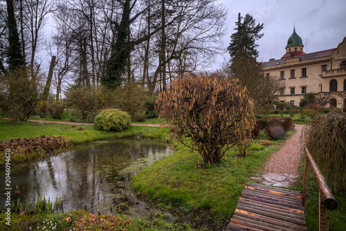 Průhonice Castle park with pond and wooden bridge
