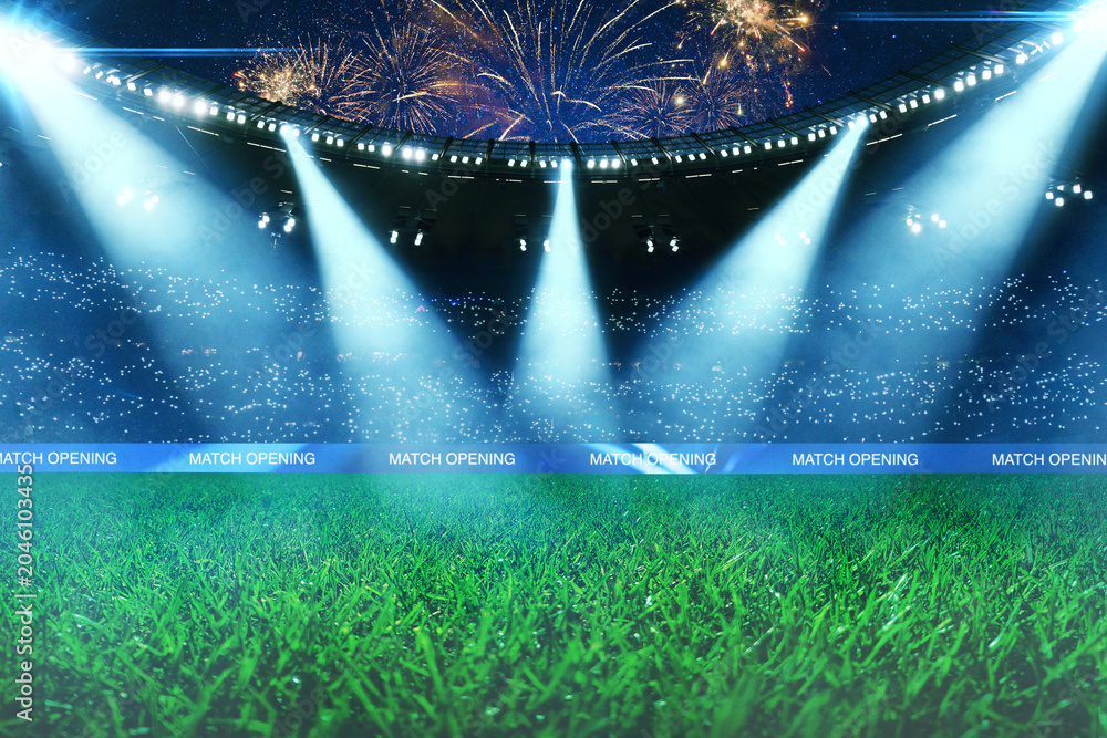 Naklejka premium Empty green soccer field of a huge stadium with bright spotlights, fans in the stands and spectacular fireworks in the night sky during a match opening ceremony. Professional sport arena background.