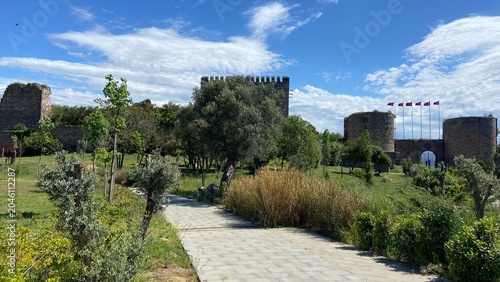 Front entrance of the historic Eskihisar Castle in Gebze, Kocaeli, Türkiye, featuring its ancient stone towers under a clear blue sky.