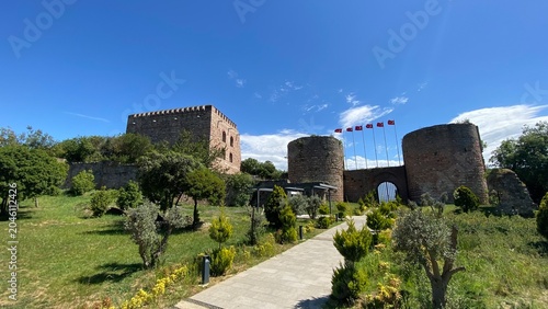 Front entrance of the historic Eskihisar Castle in Gebze, Kocaeli, Türkiye, featuring its ancient stone towers under a clear blue sky.