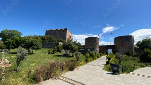 Front entrance of the historic Eskihisar Castle in Gebze, Kocaeli, Türkiye, featuring its ancient stone towers under a clear blue sky.