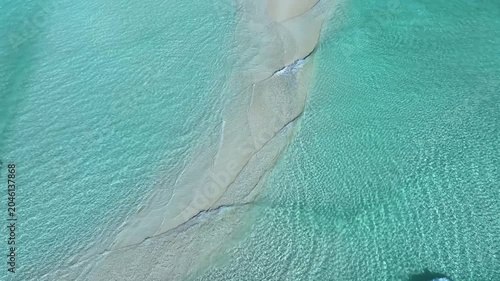 Aerial view of a pristine white sandbar surrounded by crystal clear turquoise ocean water in Fulhadhoo, Baa Atoll, Maldives.