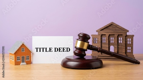 Title deed document with judge gavel and house models, real estate law and property auction concept, legal ownership and mortgage foreclosure