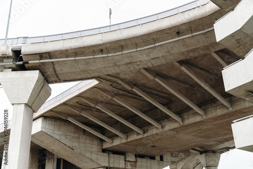 Obraz na plátně Massive concrete overpass viewed from below showing engineering details