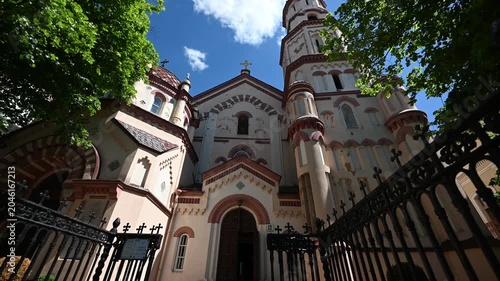 Majestic Orthodox Church of St. Nicholas in Vilnius, Lithuania, a Historic Architectural Landmark, Stands Tall Under a Clear Blue Sky on a Beautiful Sunny Day, Framed by Lush Green Trees.