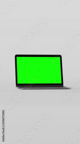Seamless loop of rotating smartphone, laptop, tablet, and smartwatch. Green screens with tracking markers for easy content replacement on a neutral grey background. 3D digital device mockup