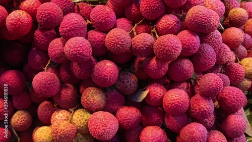 Colorful Display of Sweet Ripe Lychees Arranged in Layers for Sale at Fresh Fruit Market
