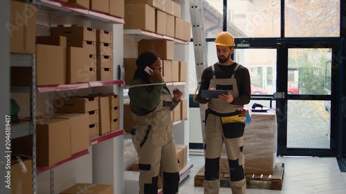 Photos Chief logistics officer and employee preparing warehouse orders for delivery, us