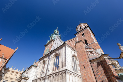 Krakow Cathedral showcases detailed architecture against a clear blue sky during midday