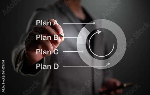 Business man writing describe about Planing chart, teamwork, and business management structure.
