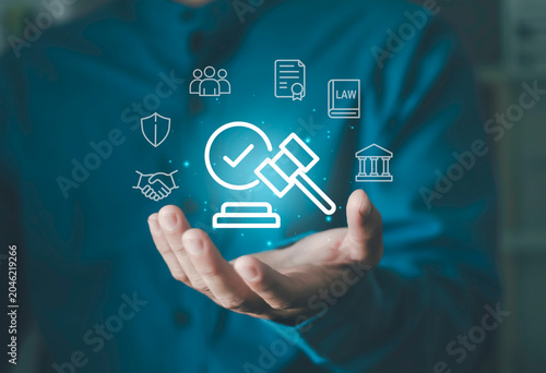 Quadro su tela Hand holding legal compliance icons, law book, shield, teamwork