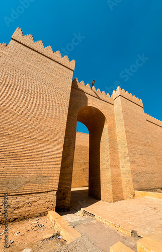 Ancient brick structure and archway in historic Babylon Iraq under clear blue sky