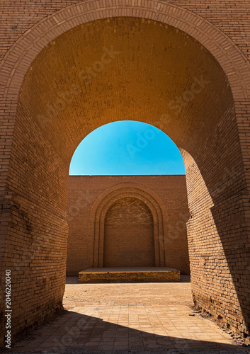 Exploring ancient architecture at Babylon in Iraq under a clear blue sky