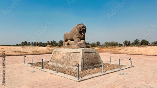 Historic lion statue stands majestically at Babylon site in Iraq under clear blue sky