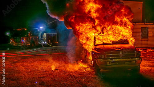 Εκτύπωση καμβά Flames rise high as a truck catches fire during a training drill for firefighters at night