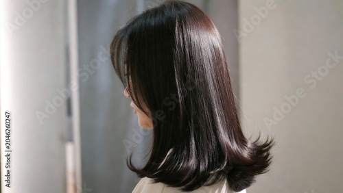 Healthy Shiny Dark Hair, Woman's Silky Brown Tresses, Elegant Hairstyle, Beauty and Care Concept, Close-up Side View