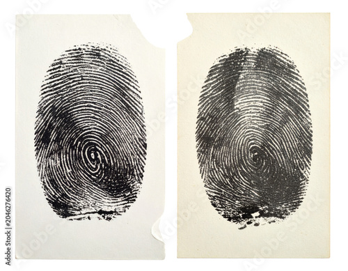 Two black ink human fingerprints stamped on vintage paper cards