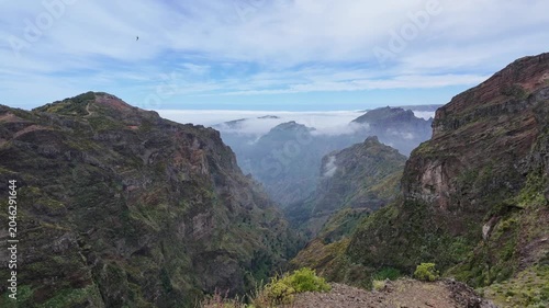 Panoramic view of massive green volcanic canyon on PR1 trail in Madeira