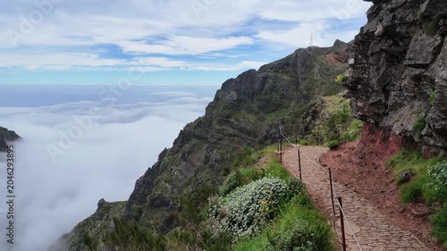 Panoramic view of hiking trail above clouds on PR1 in Madeira