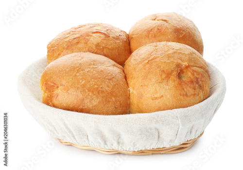 Cuadro en lienzo Freshly baked buns in wicker basket isolated on white
