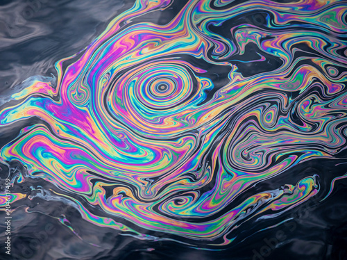 Rainbow Oil Slick Interference Pattern on Water — Abstract Iridescent Background