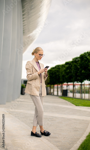Business woman checks phone...