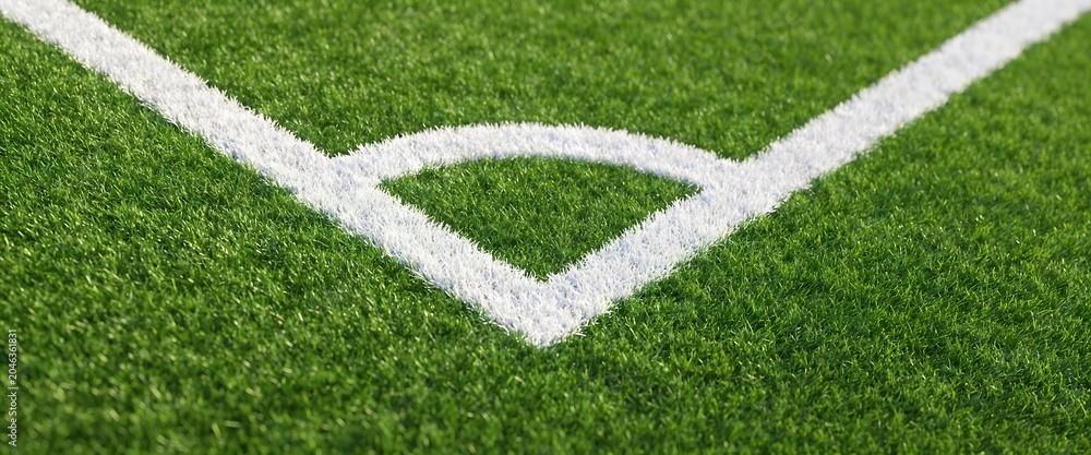 Fototapeta premium Close up of corner white line markings on a green artificial turf soccer field