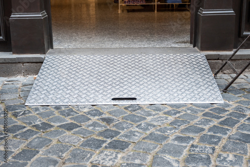 Street and accessible building entrance with ramp for wheelchair people with disability