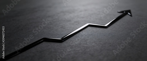 Rising business arrow graph on a dark stone background symbolizing success and financial growth