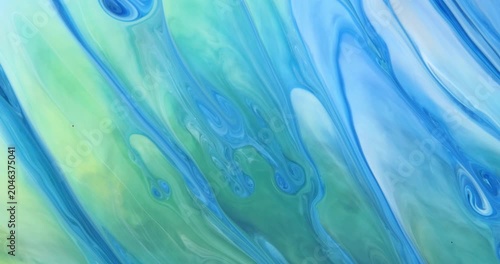 Blue background with unique moving streaks of blue, white, green, lilac tones. Abstract art. Marble texture.