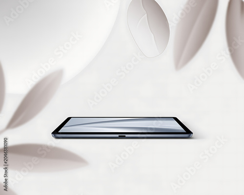 Sleek Tablet Device with Reflective Screen on a White Surface with Soft Focus Leaves tablet computer