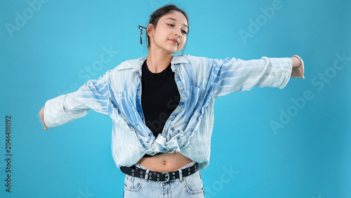 Artistic portrait of a cheerful young woman stretching arms wide open