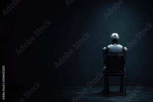 Humanoid robot sits alone in a dark room. Space for text.