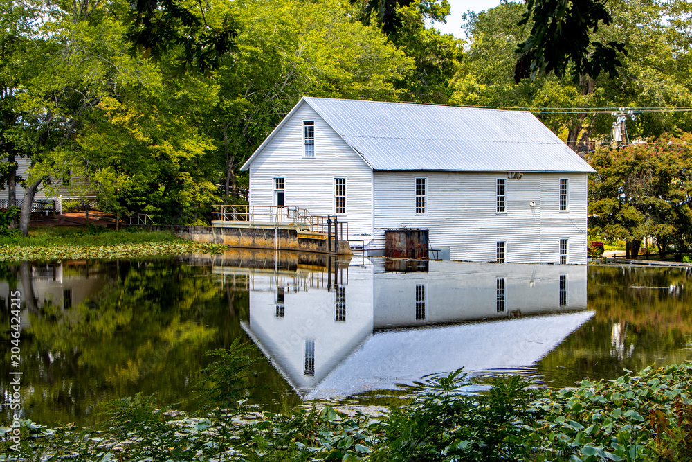 Ταπετσαρία reflection of old grist mill in the water