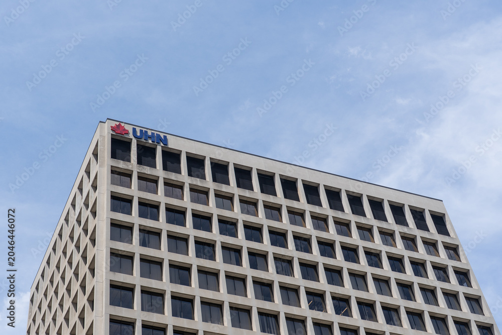 Naklejka premium Toronto, Ontario, Canada - June 2, 2026: UHN logo on top of the Princess Margaret Cancer Centre building on University Avenue in Toronto, Ontario, Canada. UHN is recognized as the Canadian